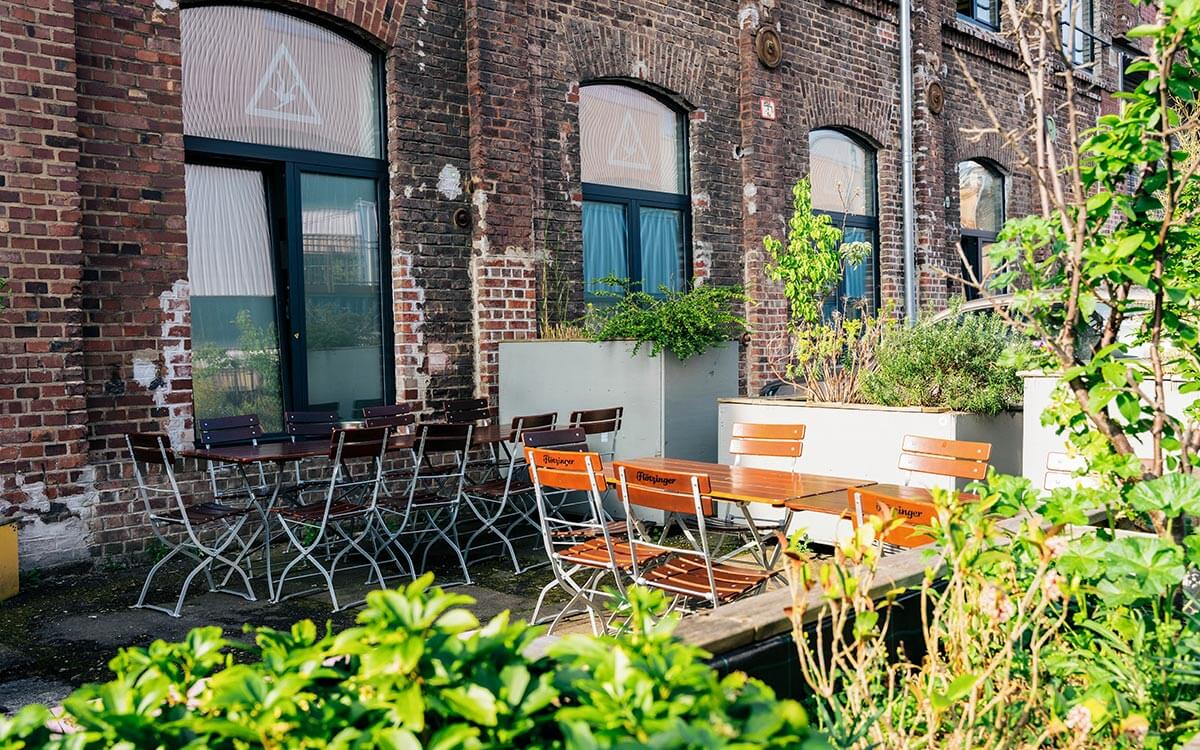 Gemütlicher Sitzbereich draußen vor dem Stuntwerk im schönen Biergarten